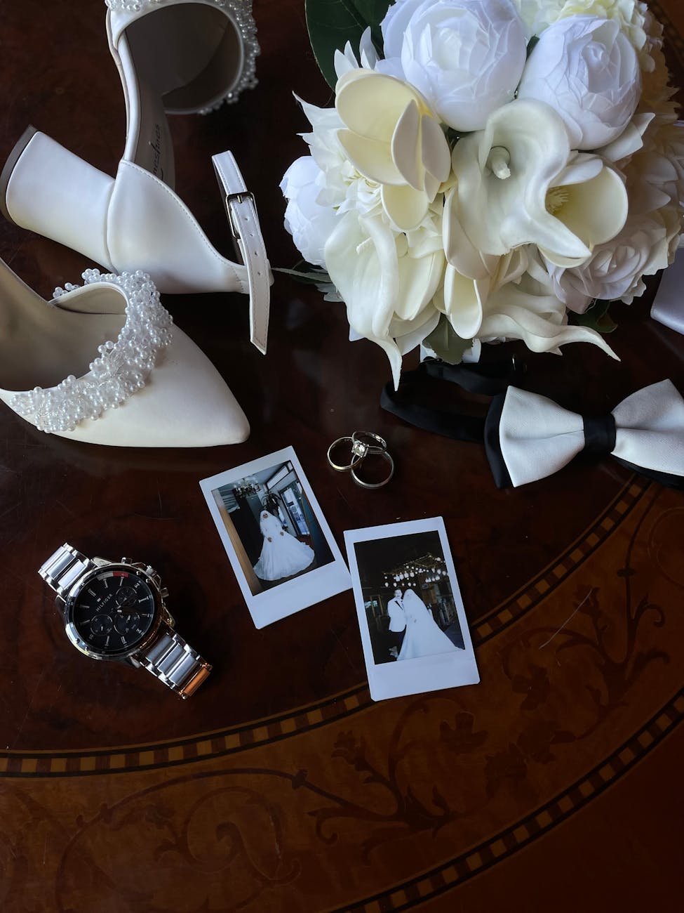 a wedding photo album wedding shoes and a watch