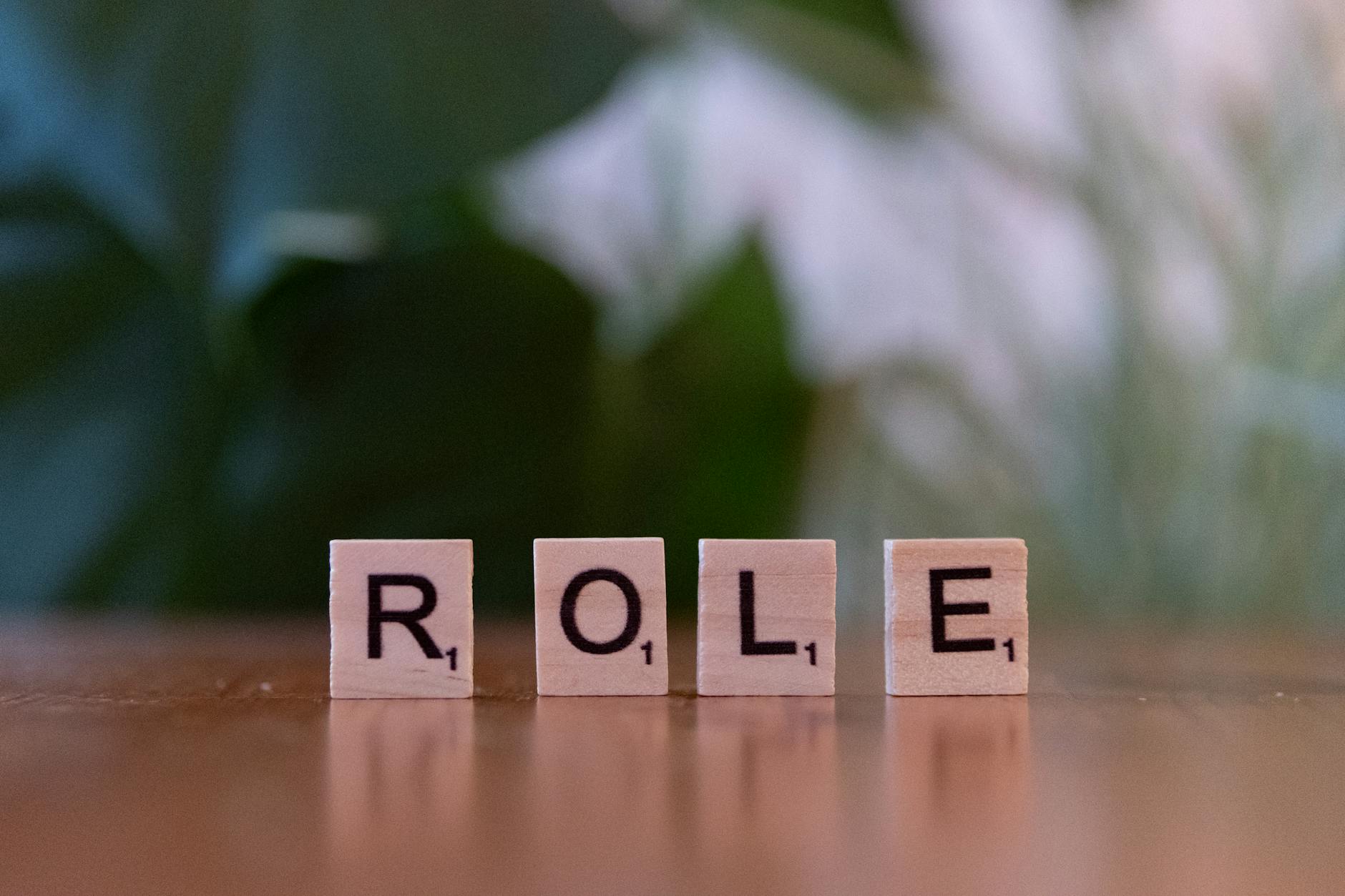 wooden scrabble tiles spelling role