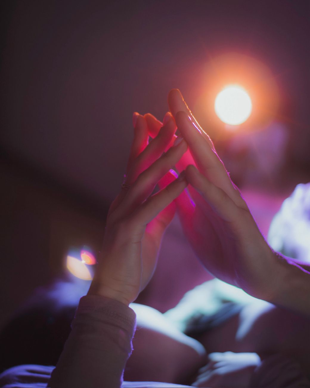 light over touching hands